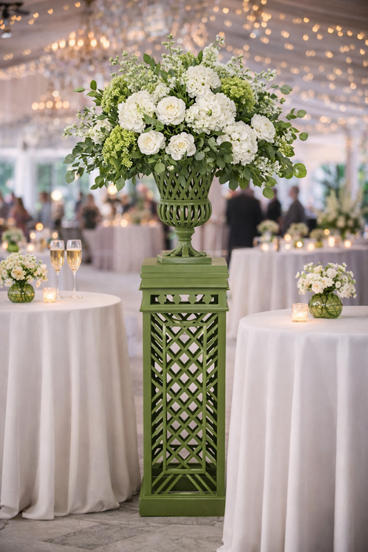 a green pedestal with white flowers and green vases on it