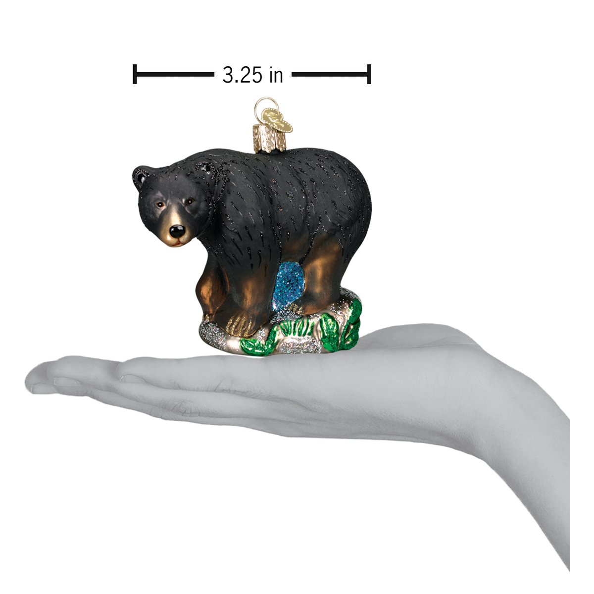 a hand holding a bear ornament