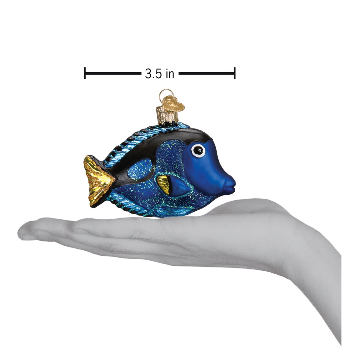 a hand holding a blue fish ornament