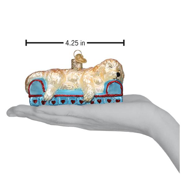 a hand holding a christmas ornament