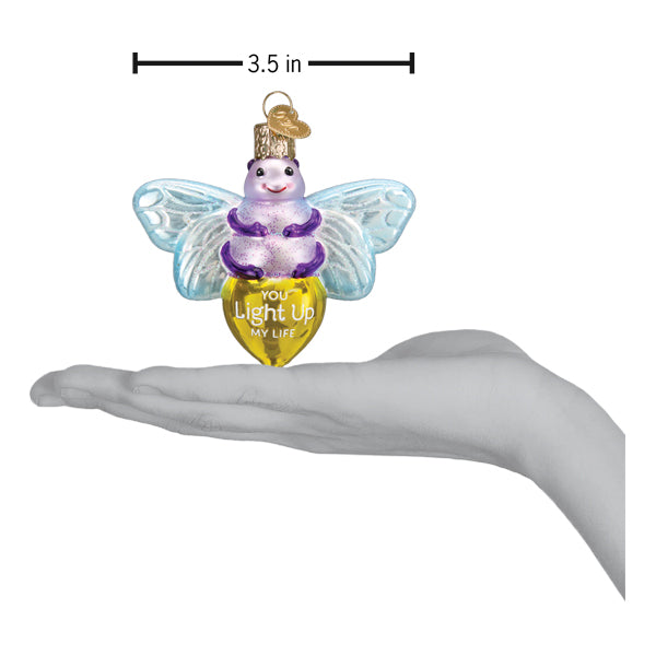 a hand holding a christmas ornament