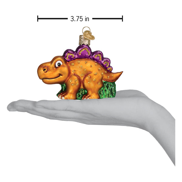 a hand holding a dinosaur ornament