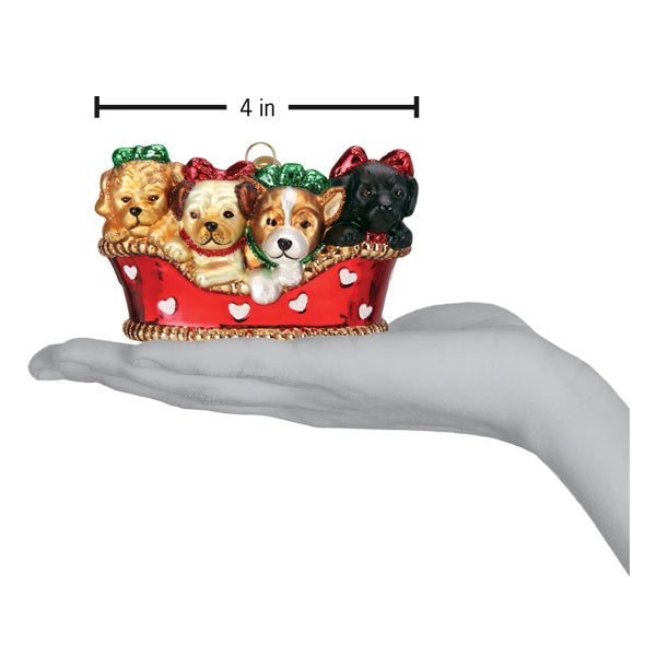 a hand holding a red and white dog ornament