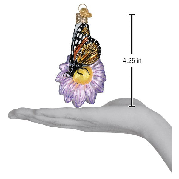 a hand holding a butterfly ornament