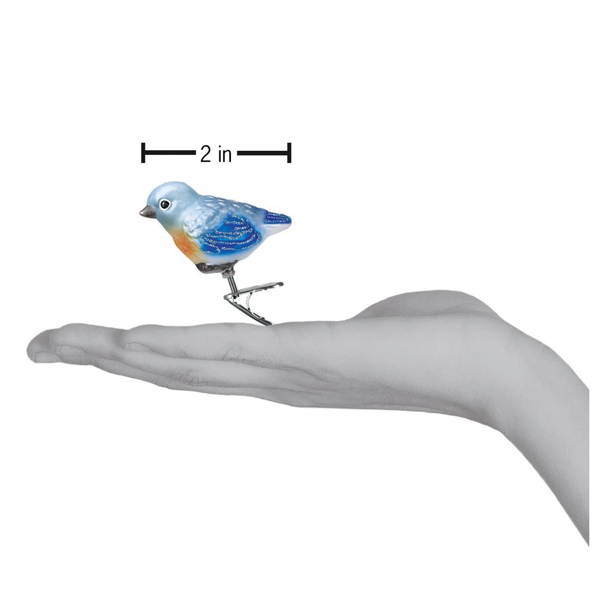 a hand holding a small bird