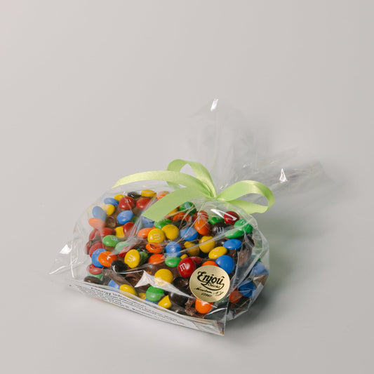 a bag of candy with a green ribbon