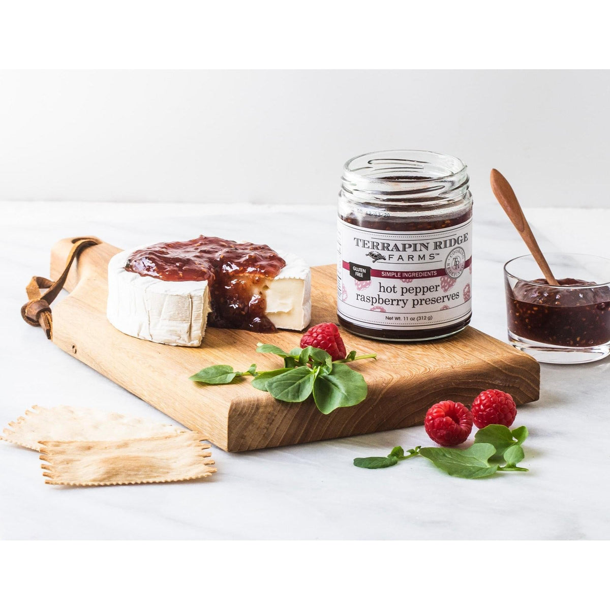 a cheese and jam on a cutting board