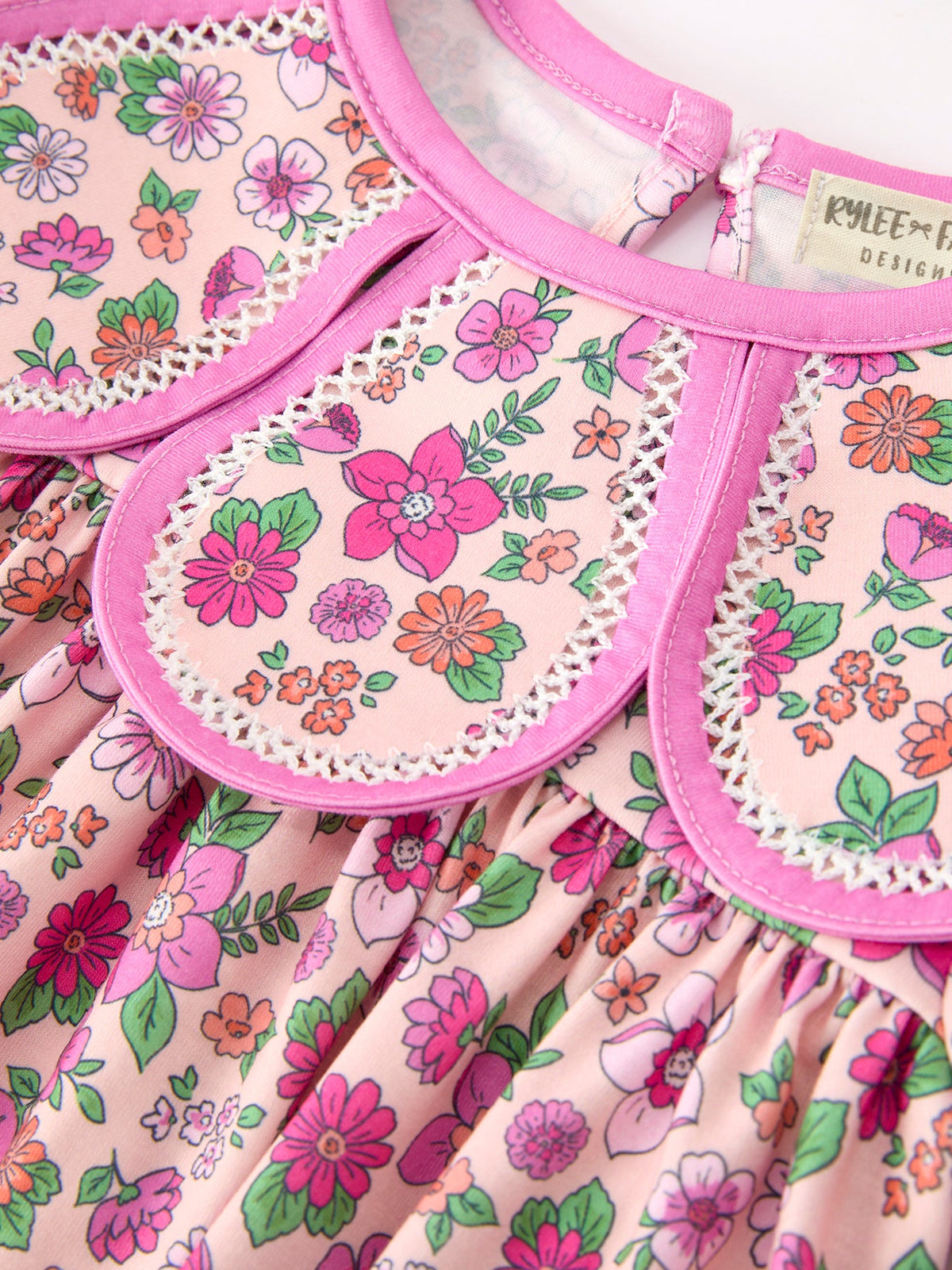 a pink and white dress with pink flowers on it