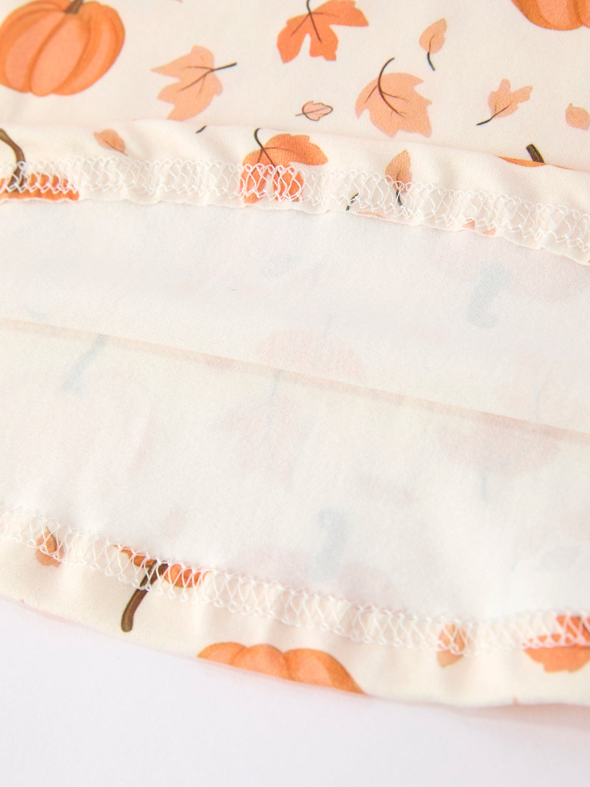 a fabric with orange leaves on it