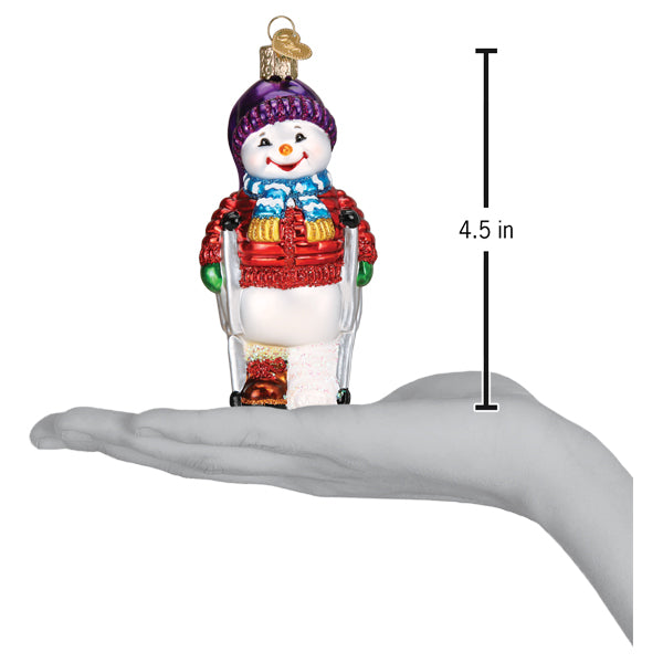 a hand holding a snowman ornament