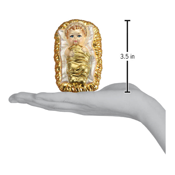 a hand holding a small gold and white statue