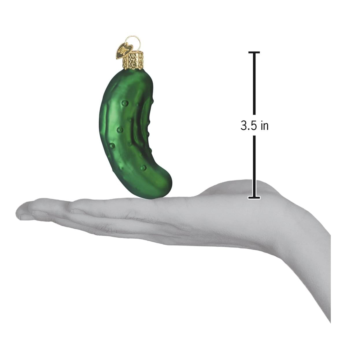a hand holding a cucumber ornament