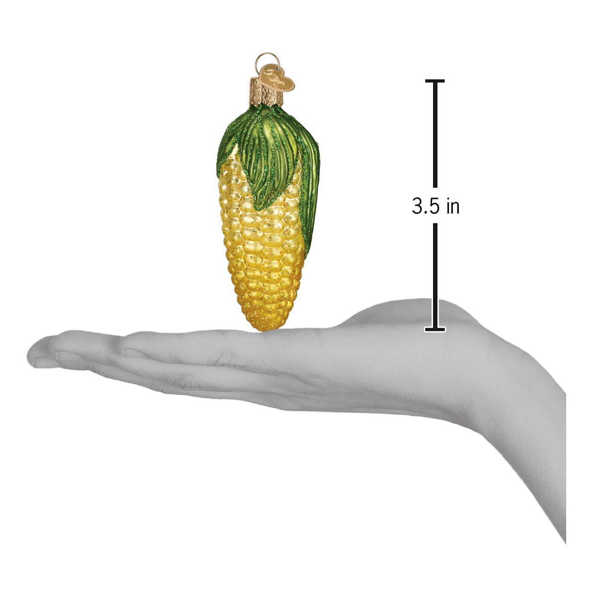 a hand holding a corn ornament