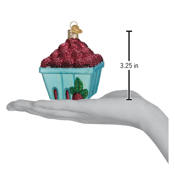 a hand holding a christmas ornament