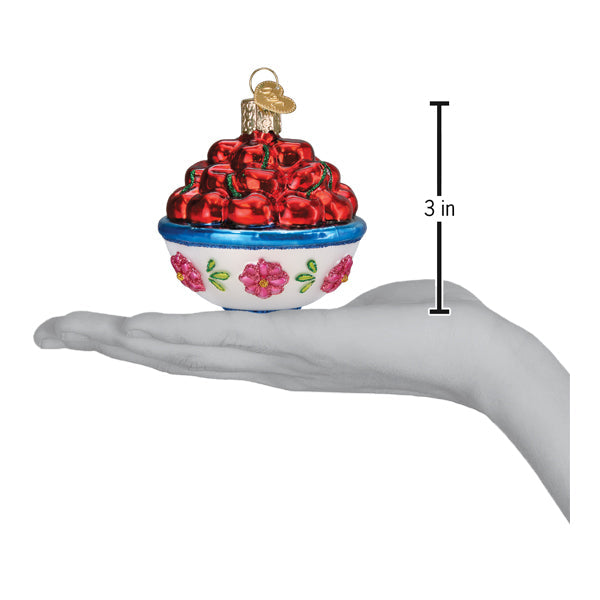 a hand holding a christmas ornament