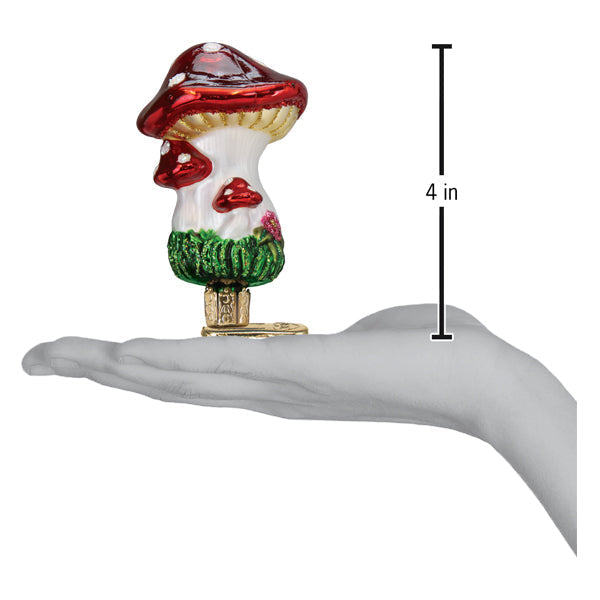 a hand holding a small mushroom shaped object