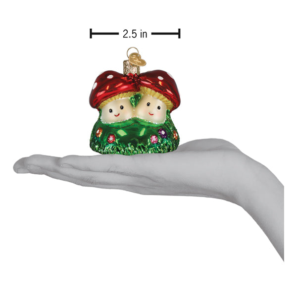 a hand holding a christmas ornament