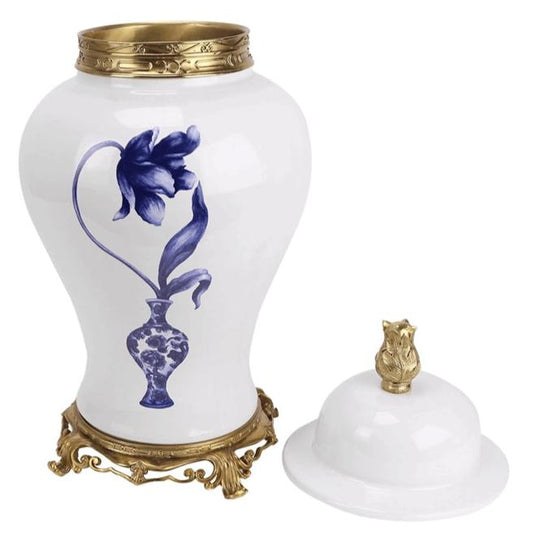 a white and gold vase with a blue flower on it