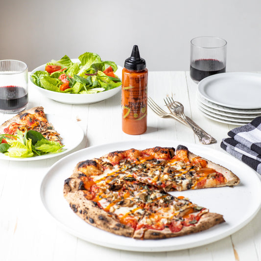 a plate of pizza and salad on a table
