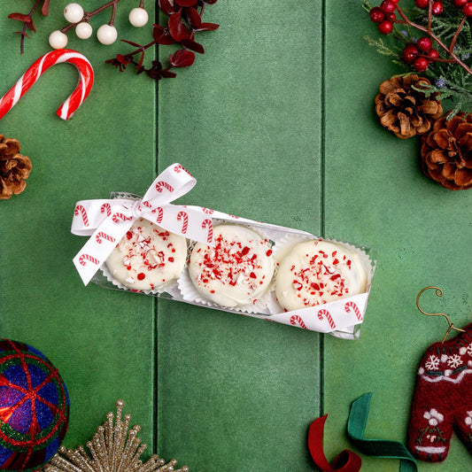a box of cookies with white frosting and red sprinkles