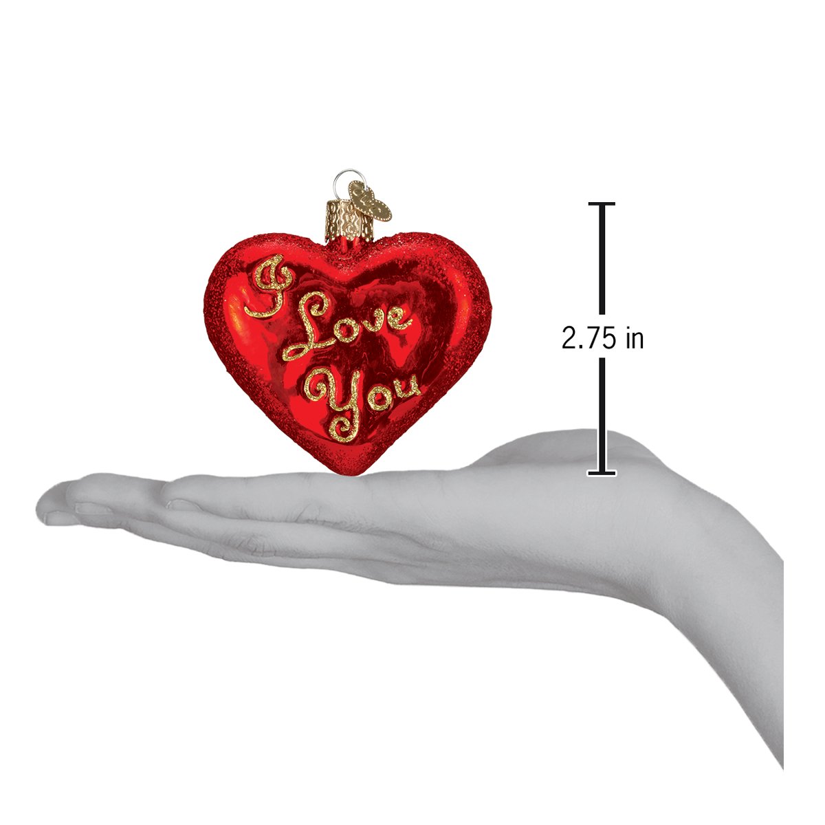 a hand holding a heart shaped ornament