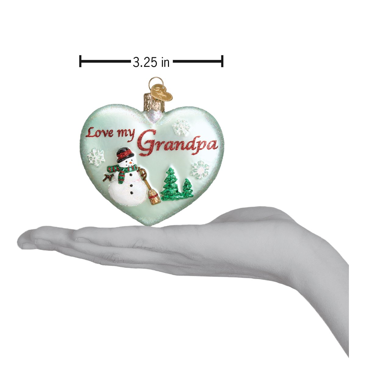 a hand holding a heart shaped ornament