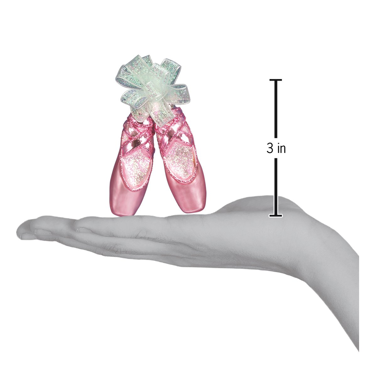 a hand holding a pair of pink ballet shoes
