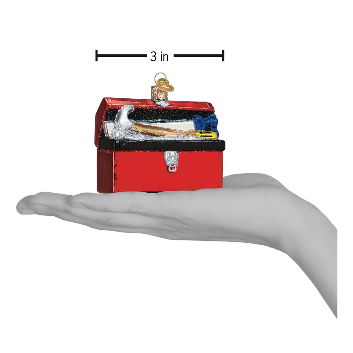 a hand holding a red toolbox ornament