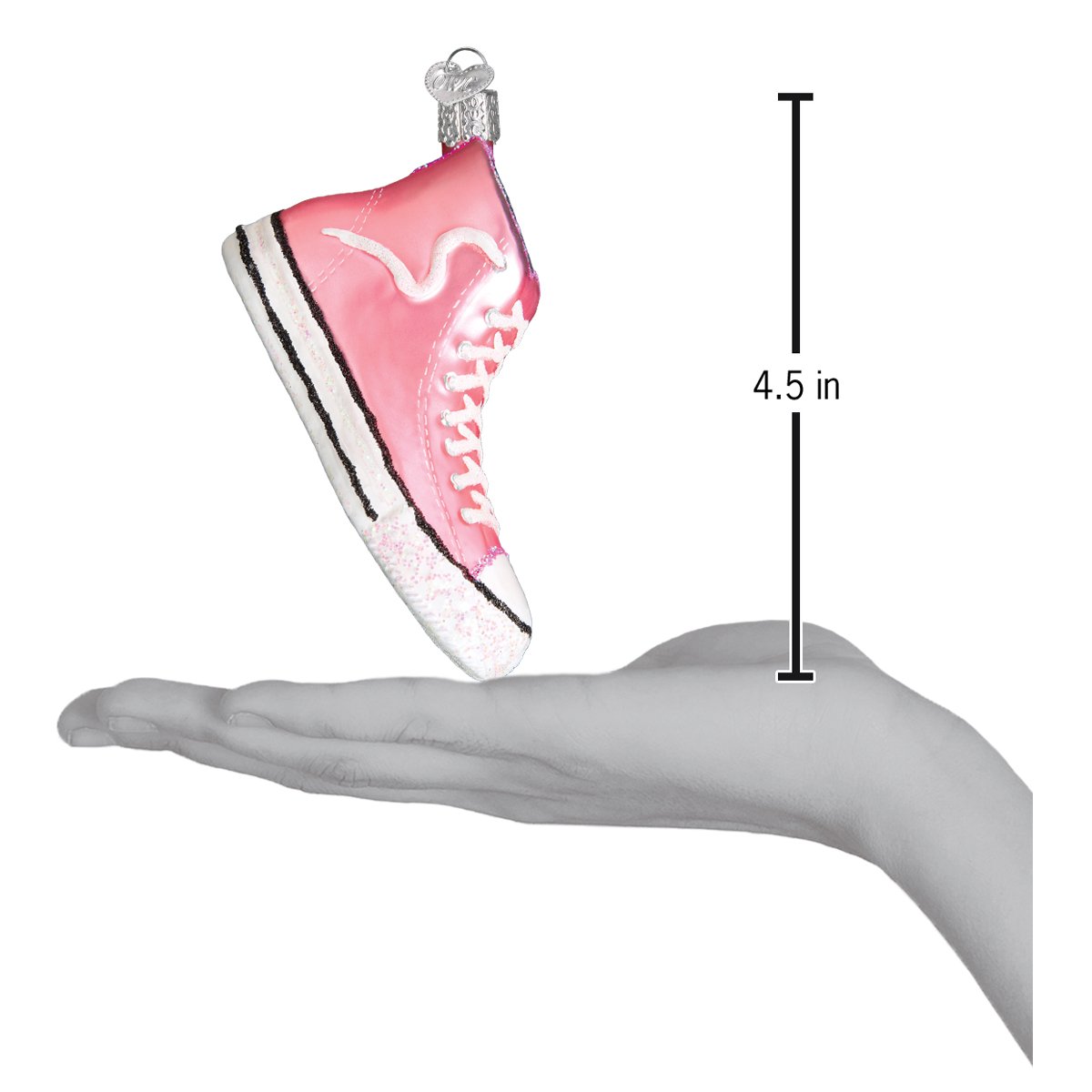 a hand holding a pink shoe ornament
