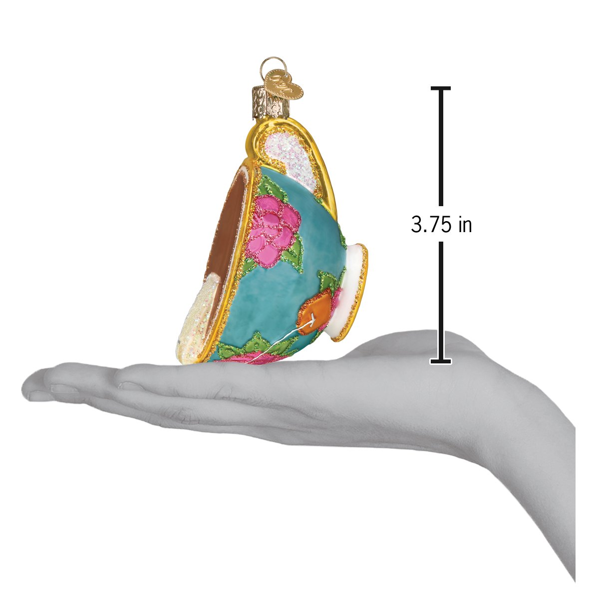 a hand holding a teacup ornament