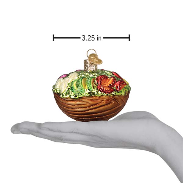 a hand holding a christmas ornament