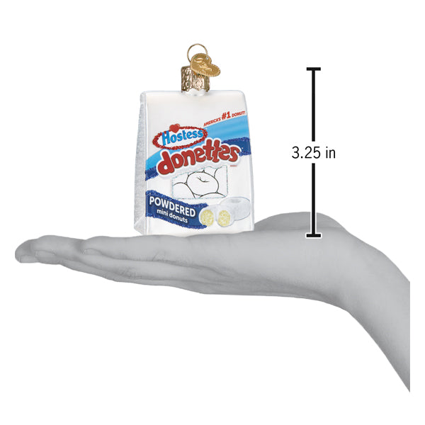 a hand holding a package of powdered sugar