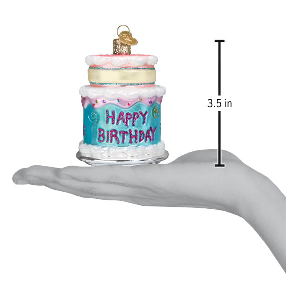 a hand holding a birthday cake ornament