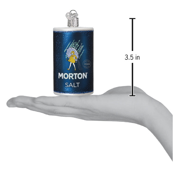 a hand holding a salt shaker