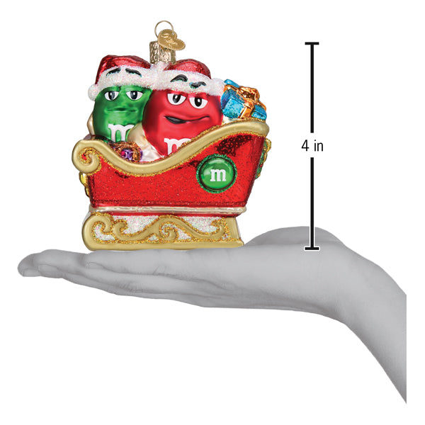 a hand holding a christmas ornament
