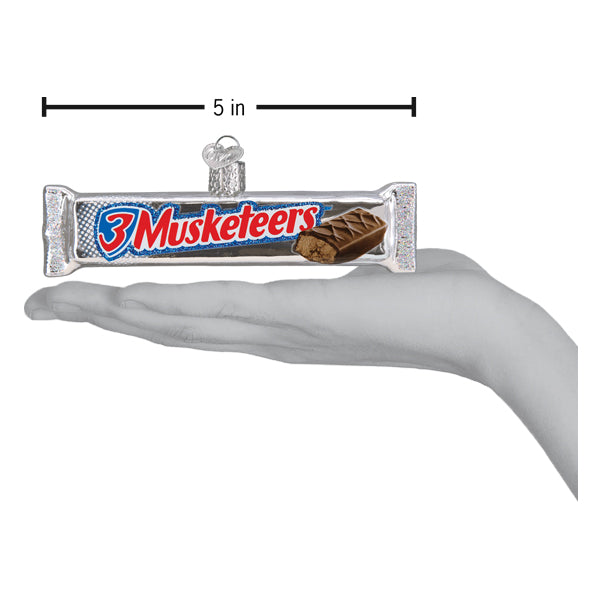a hand holding a candy bar