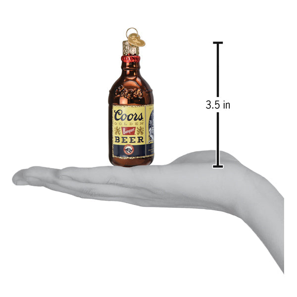 a hand holding a small brown bottle