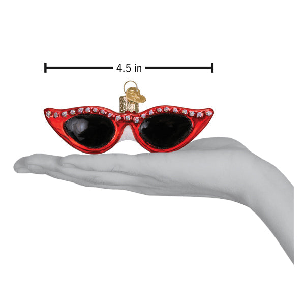 a hand holding a christmas ornament