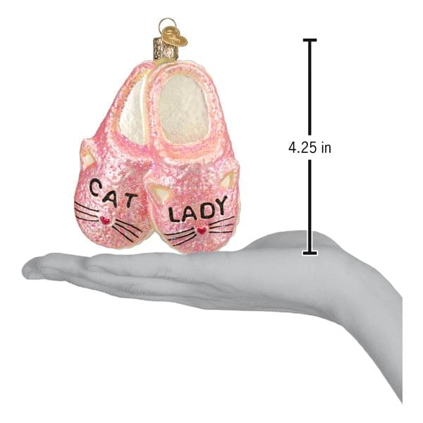 a hand holding a pink ornament