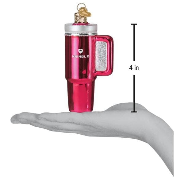 a hand holding a pink mug