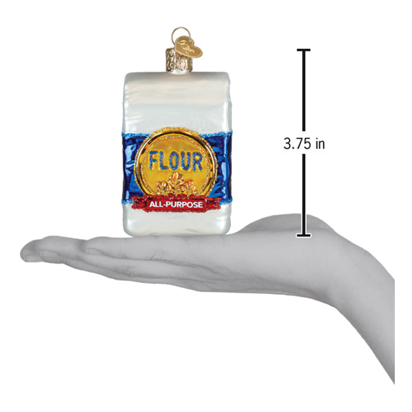 a hand holding a small bag of flour