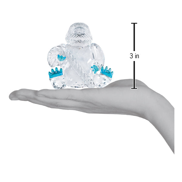 a hand holding a glass figurine