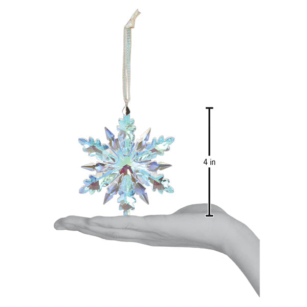 a hand holding a snowflake ornament