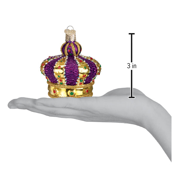 a hand holding a gold crown