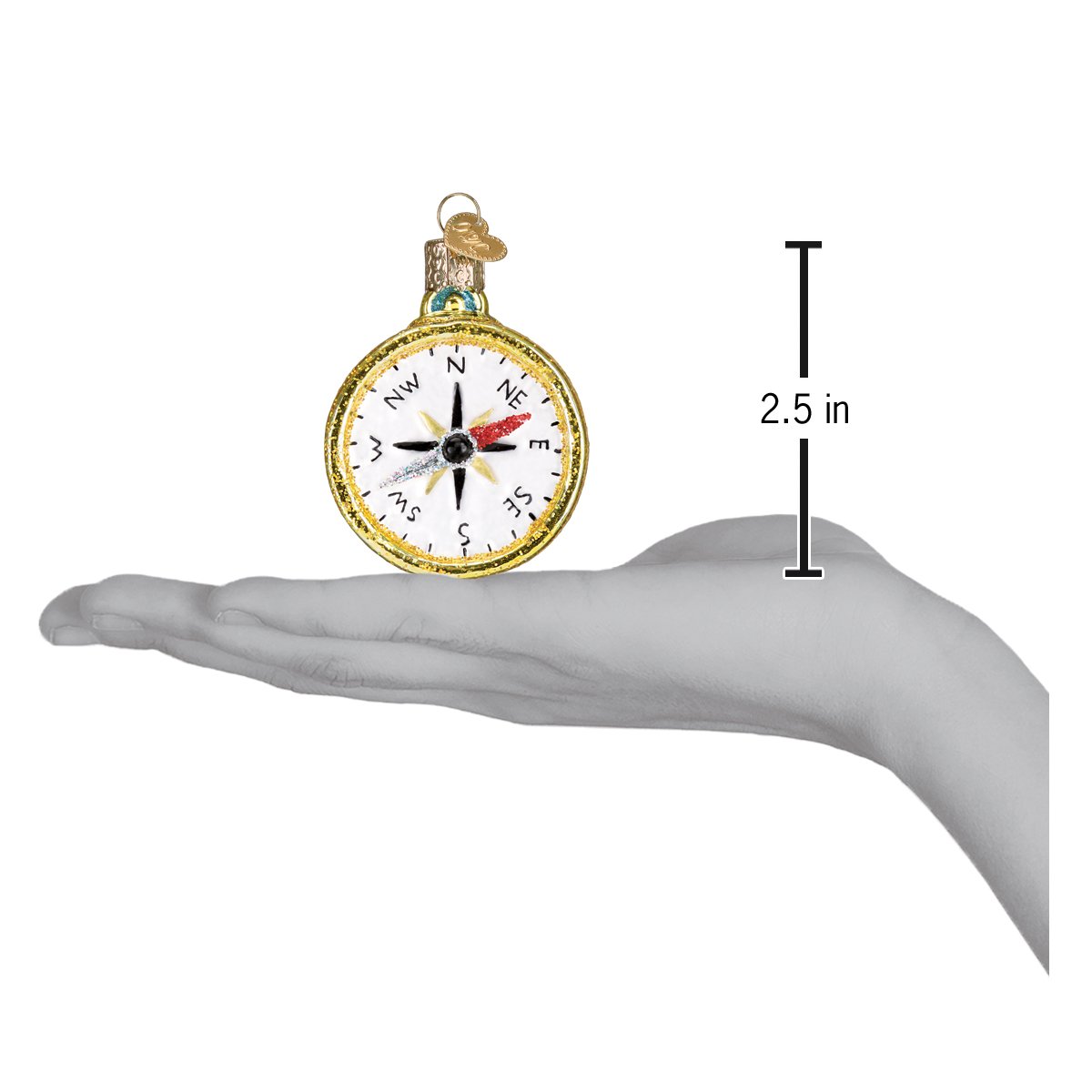 a hand holding a compass ornament