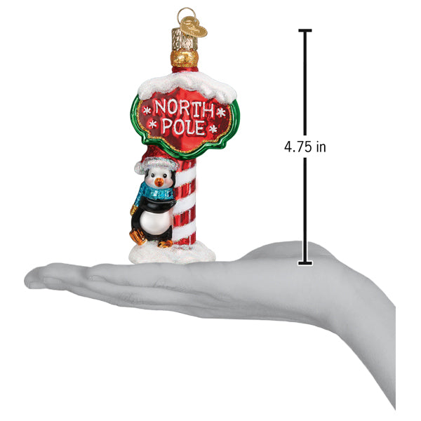 a hand holding a christmas ornament