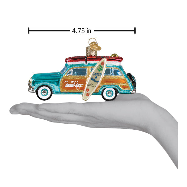 a hand holding a christmas ornament