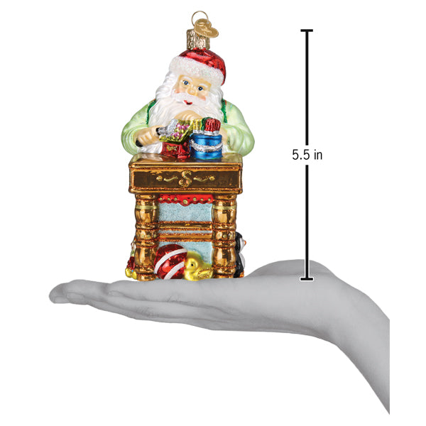 a hand holding a christmas ornament