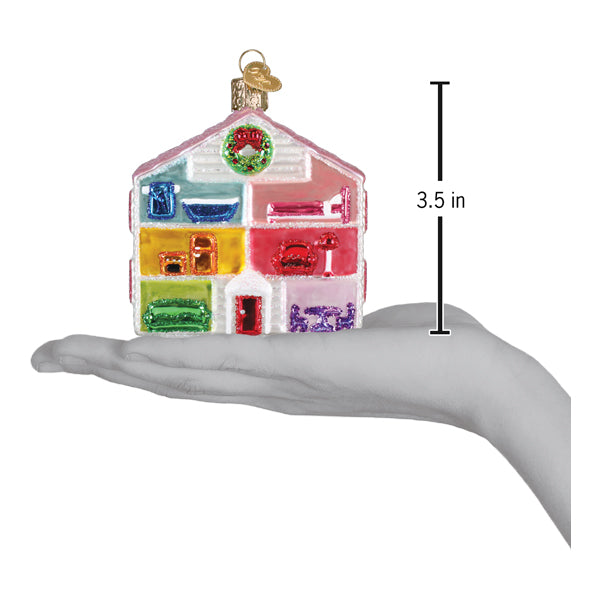 a hand holding a colorful house ornament