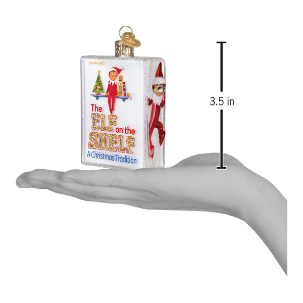 a hand holding a christmas ornament